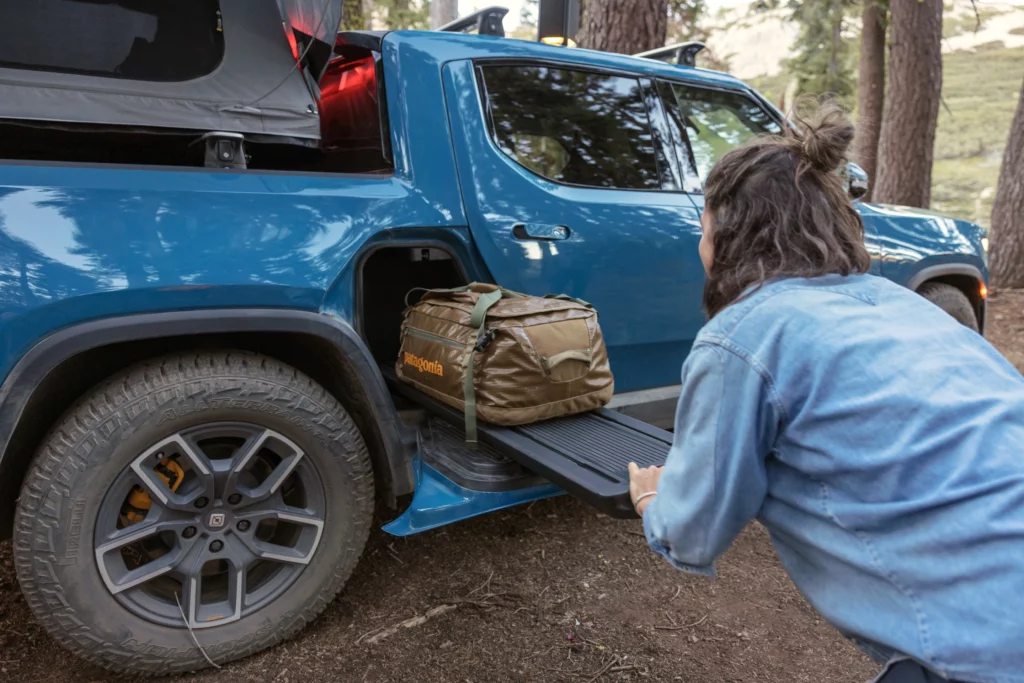 Woman accessing storage in Rivian R1T Truck