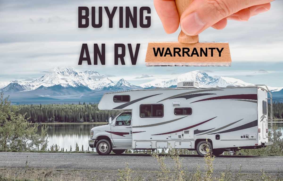 fingers holding a warranty sign over an RV