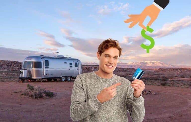 Man holding a credit card next to an RV