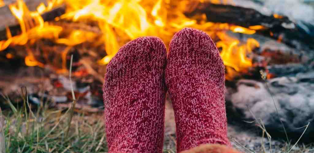 warm feet by campfire