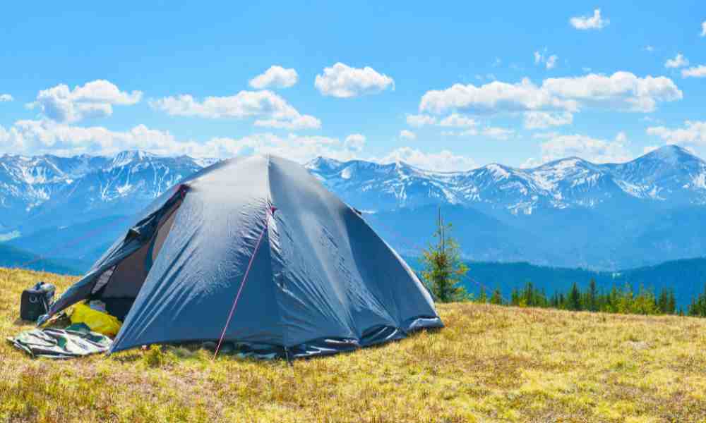 tent on grass hill in remote area