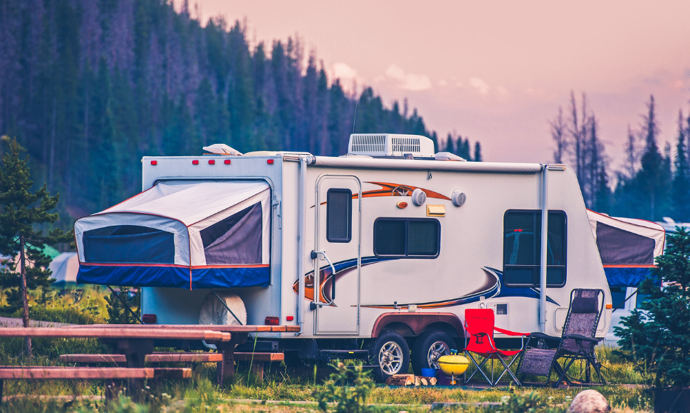 Travel trailer with tent rooms at campground