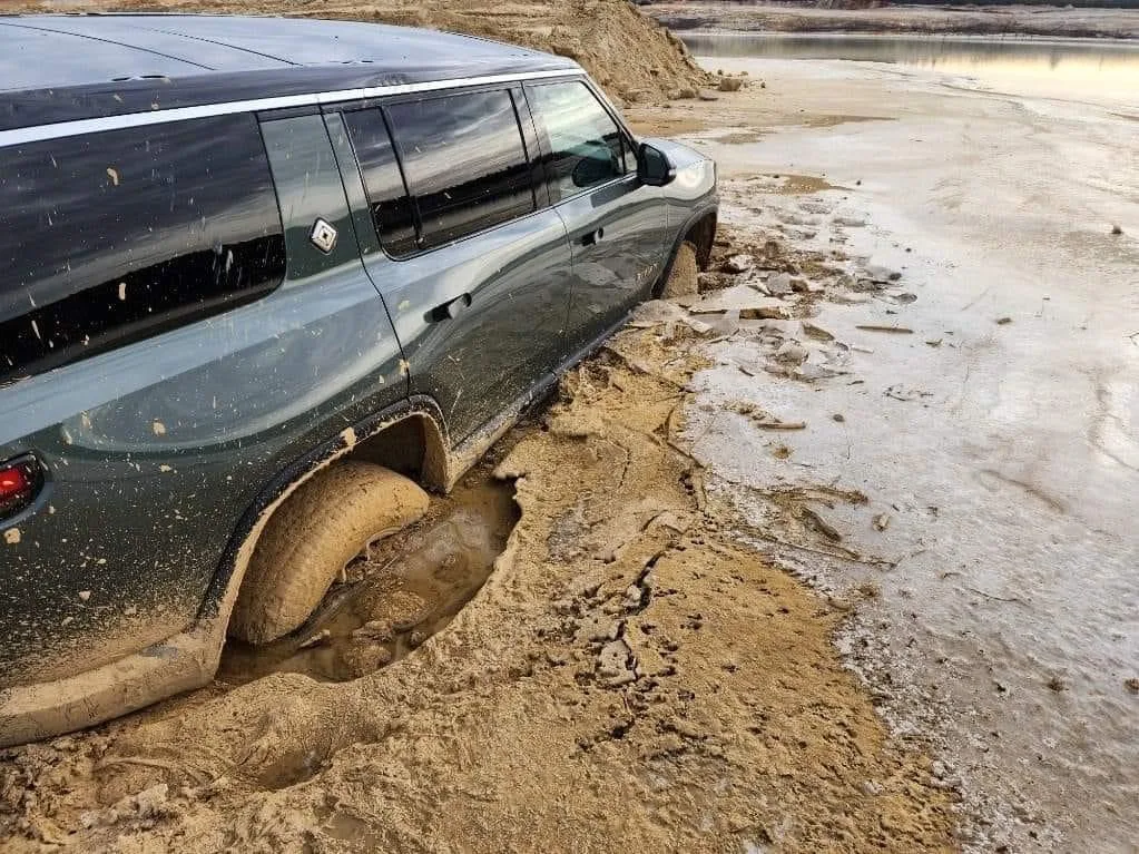 Rivian RS1 driving through mud