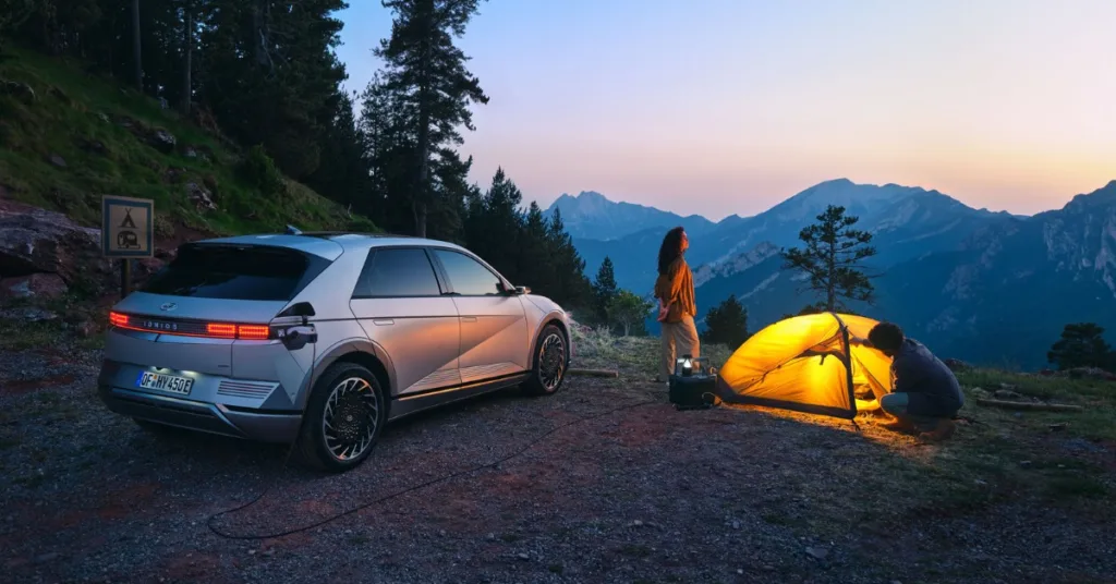 Woman camping in the mountains with Hyundai Ionic 5